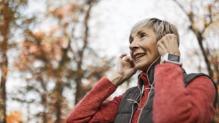 Senior woman jogging in park.