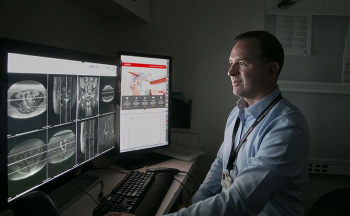 Image of doctor looking a radollogy images on his computer