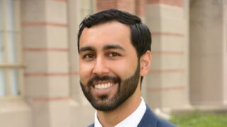 Man with dark hair wearing a suite