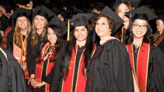 Keck School of Medicine of USC students smile at a graduation ceremony