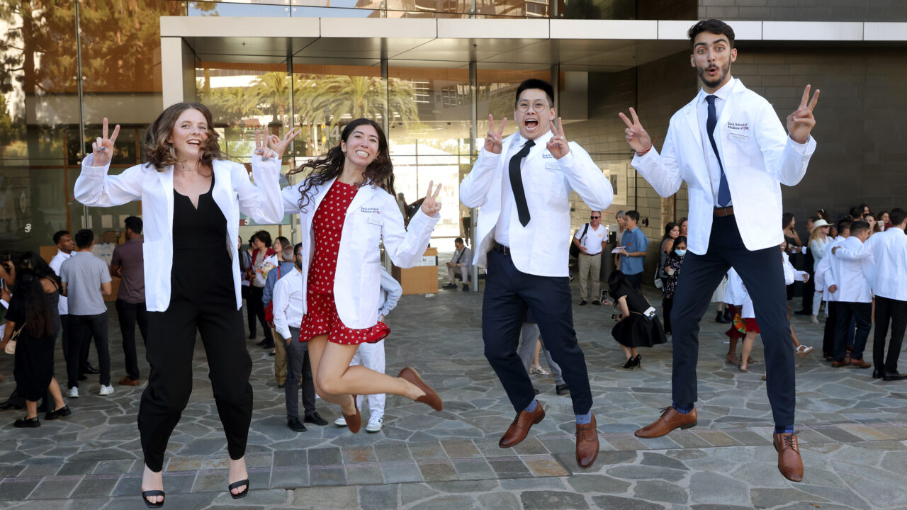 Keck Medicine of USC students jump in the air