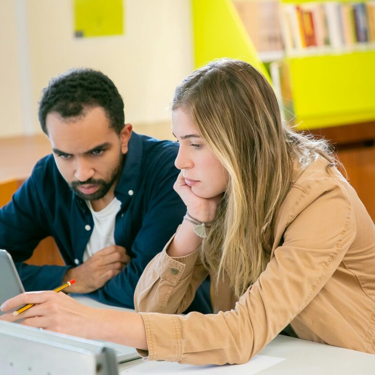 students doing homework together in library