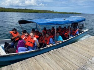 Students on boat arriving at dock in Panama