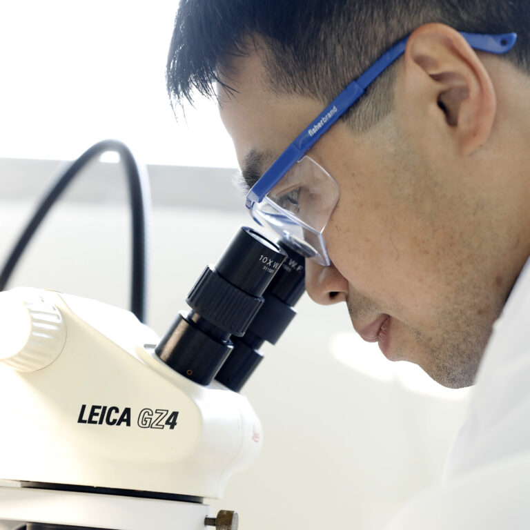 Man looking into microscope