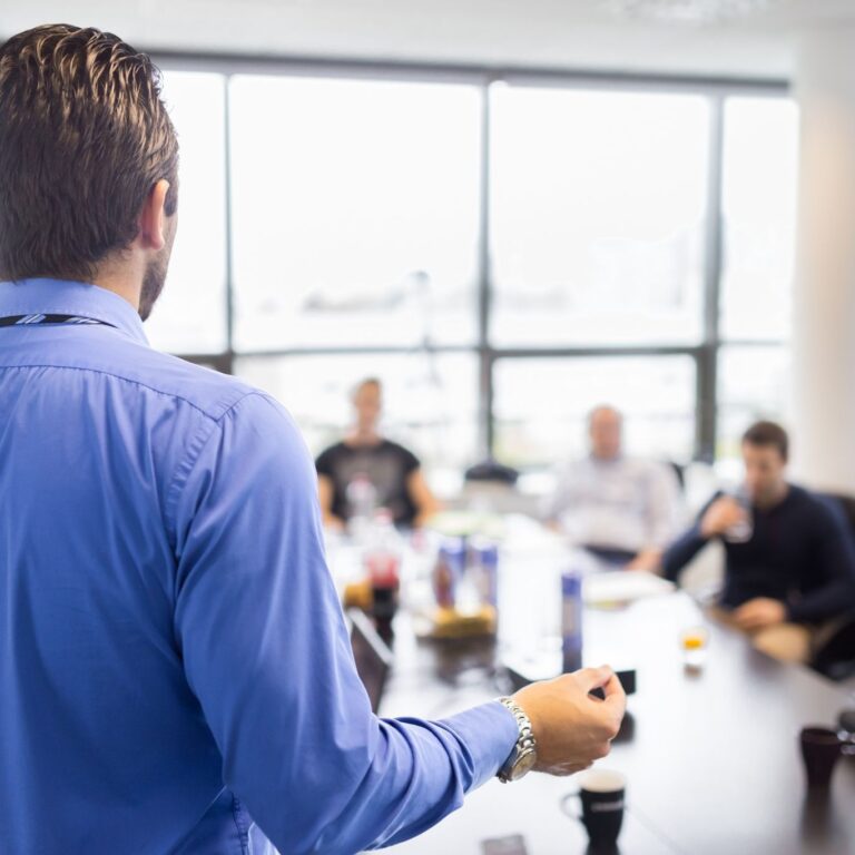 man standing in front of meeting room