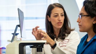 Faculty and student confer