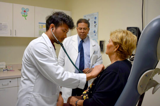 Student examining a patient