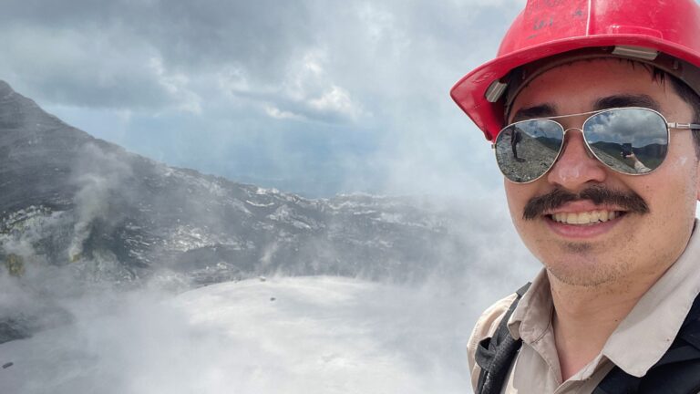 Student standing infront of volcano
