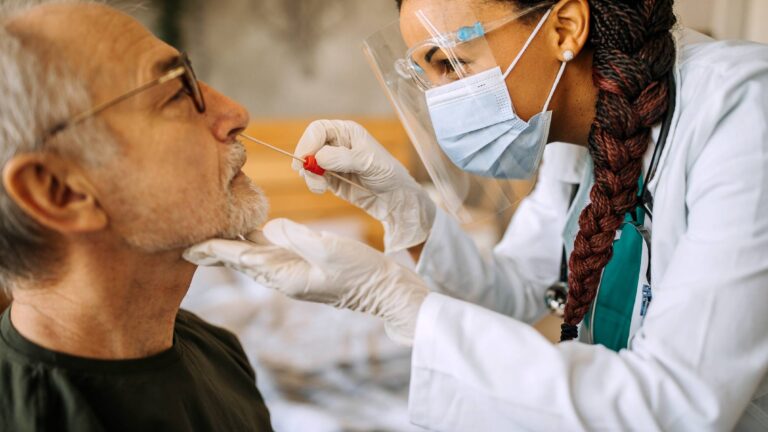 A patient having his nostril swabbed