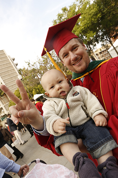A graduate shows a Victory sign after the Keck School of Medicine of USC MD/PhD and MD commencement ceremony May 14, 2016 at McCarthy Quad on the University Park Campus. 5/14/16 Los Angeles, CA Keck School of Medicine of USC Commencement Photo by: Steve Cohn www.stevecohnphotography.com (310) 277-2054 © 2016