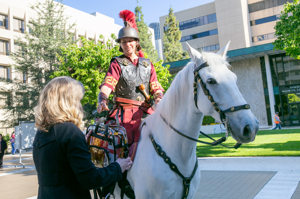 Match Day envelopes are delivered to Karen Restifo via USC mascot Traveler