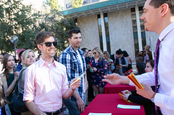 Graduating medical students wait in line to receive their envelopes during Match Day celebrations.