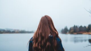 Red headed woman seen from behind in the snow