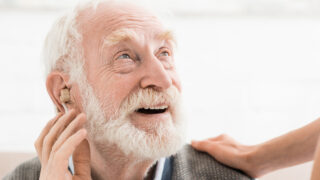 Elderly man with a hearing aid.