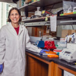 The image shows Marlena Fejzo in the lab.