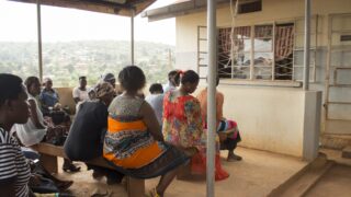 woman sit in on benches in rural setting