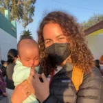 woman in mask with infant with cleft lip