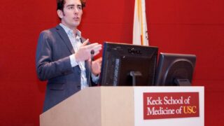 man speaks at podium