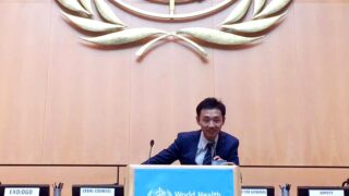 man speaks at podium at World Health Organization