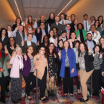 Donna Elliott, in the blue coat, celebrates with medical education colleagues.