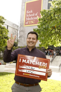 Student holding sign that says I matched at USC in Ortho specialty