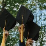 A group of people holding graduation caps