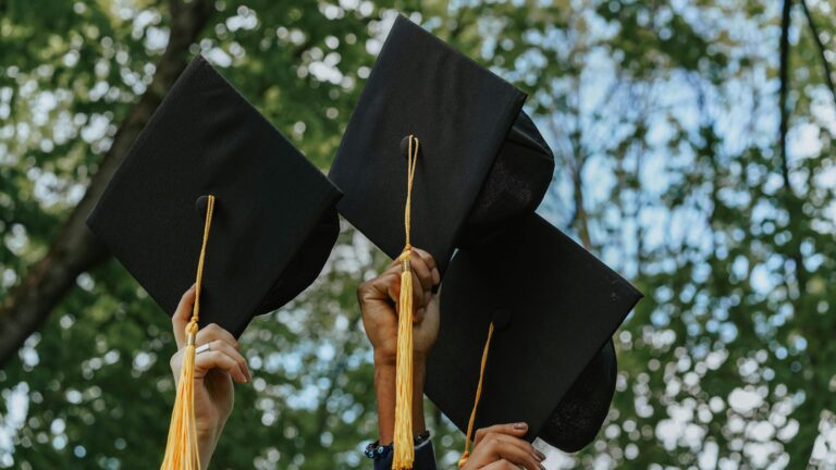 A group of people holding graduation caps
