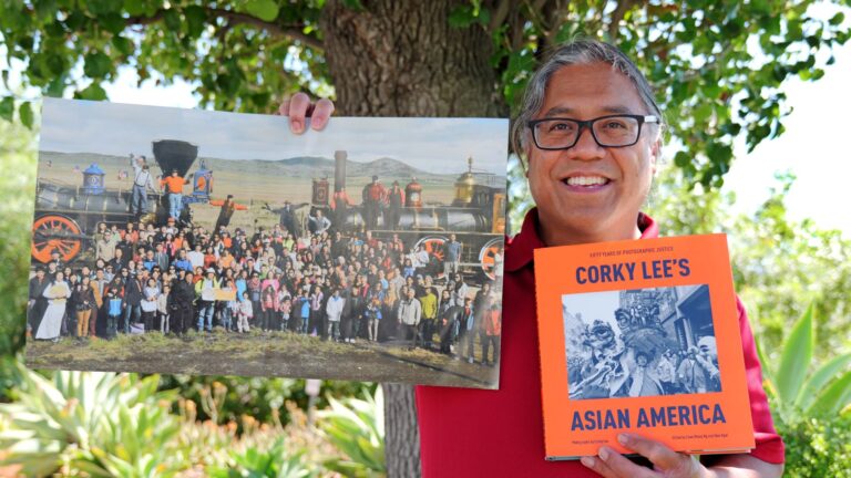 Gary San Angel holds Corky Lee's Asian America book