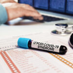 Doctor running test on blood from patient previously exposed to COVID.