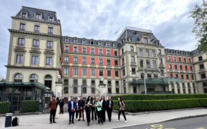 Student pose in front of historic buildings