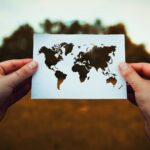 hands holding up map of the continents