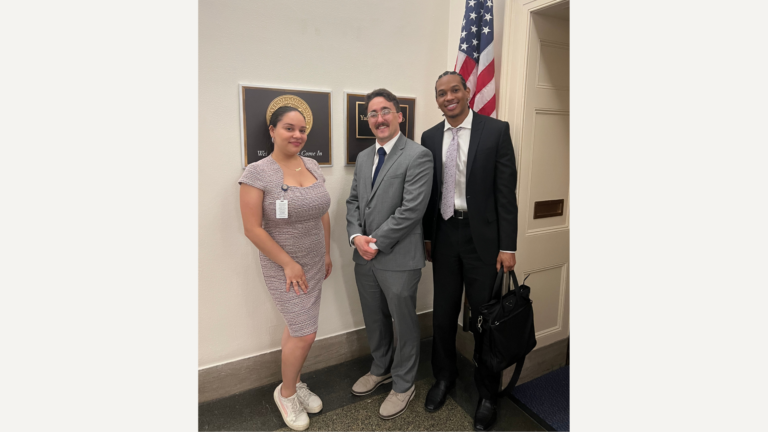 Two students pose for a picture with Elizabeth Tapia, health policy advisor to a congresswoman