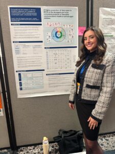 smiling researcher with scientific poster