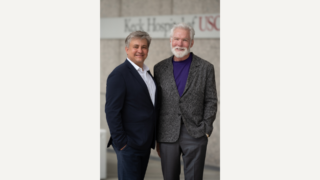 Photo shows Denis Evseenko, MD, PhD on the left next to R. Rex Parris on the right.