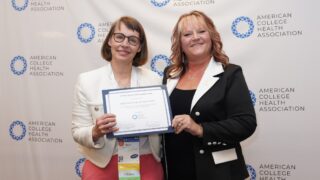 Dr. Van Orman is on the left and is receiving the award from ACHA representative Stephanie Hanenberg on her right.