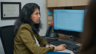 Sucheta Joshi, MD, MS, FAAP, FAES, looks over brain imaging data.