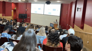 Jonathan D. Santoro, MD (standing at podium), delivers opening remarks during the DSRD Symposium.