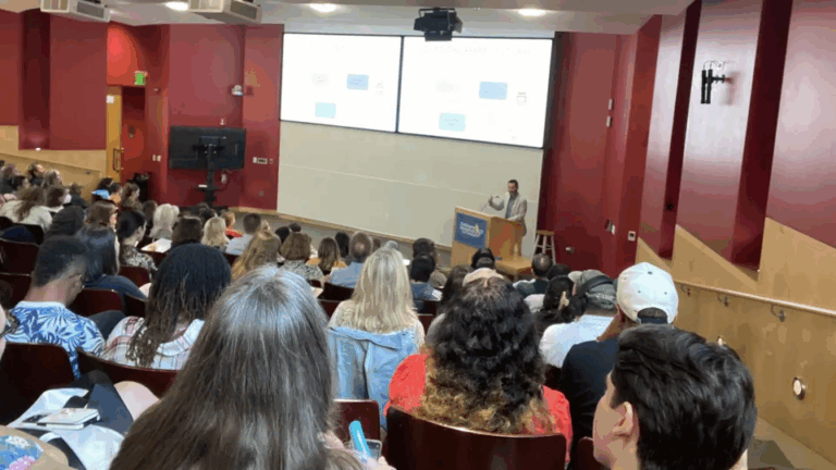 Jonathan D. Santoro, MD (standing at podium), delivers opening remarks during the DSRD Symposium.