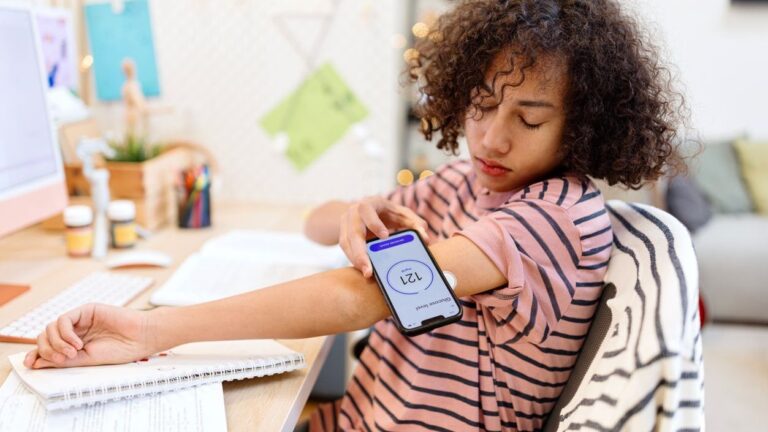 Photo shows male teenager checking his blood glucose