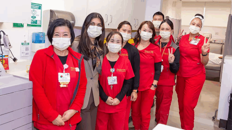 Rose Princess Riya Gupta poses with nurses at USC Norris Cancer Hospital during the Rose Court visit.