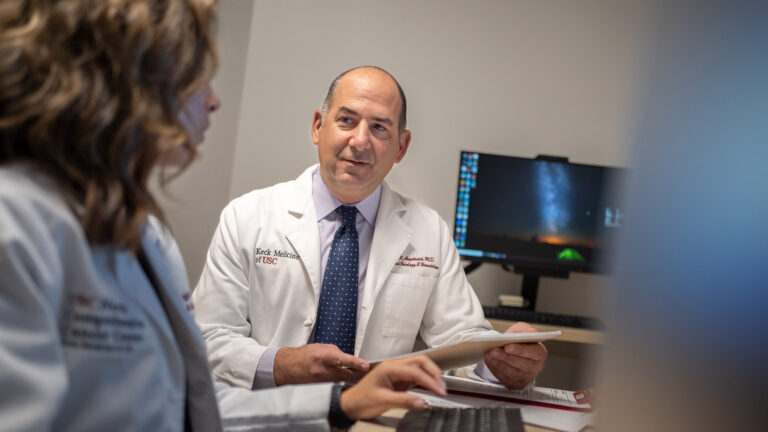 Dr. Angstreich conversing with colleague