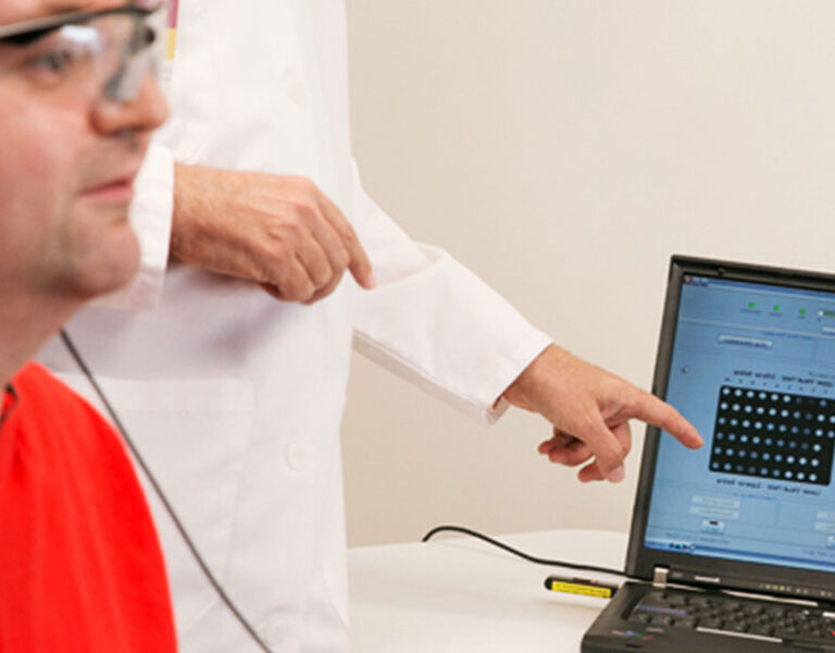 Finger pointing to a computer screen