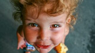Child holding a muffin