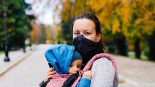 Mother and infant, both in masks