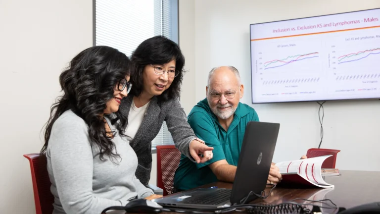 scientists consult over a computer