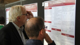 Men looking at a poster session