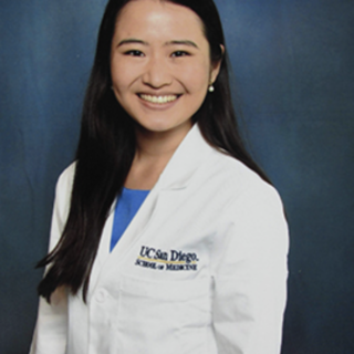 smiling medical student in white coat