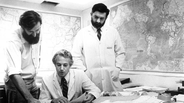 scientists consult maps