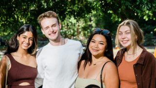 smiling students in a courtyard