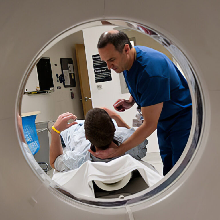 Patient with MRI machine and staff